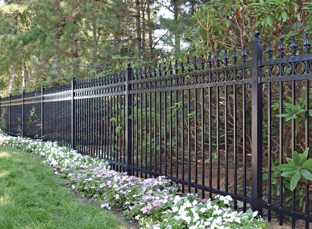 Black aluminum ornamental fence along a landscaped yard