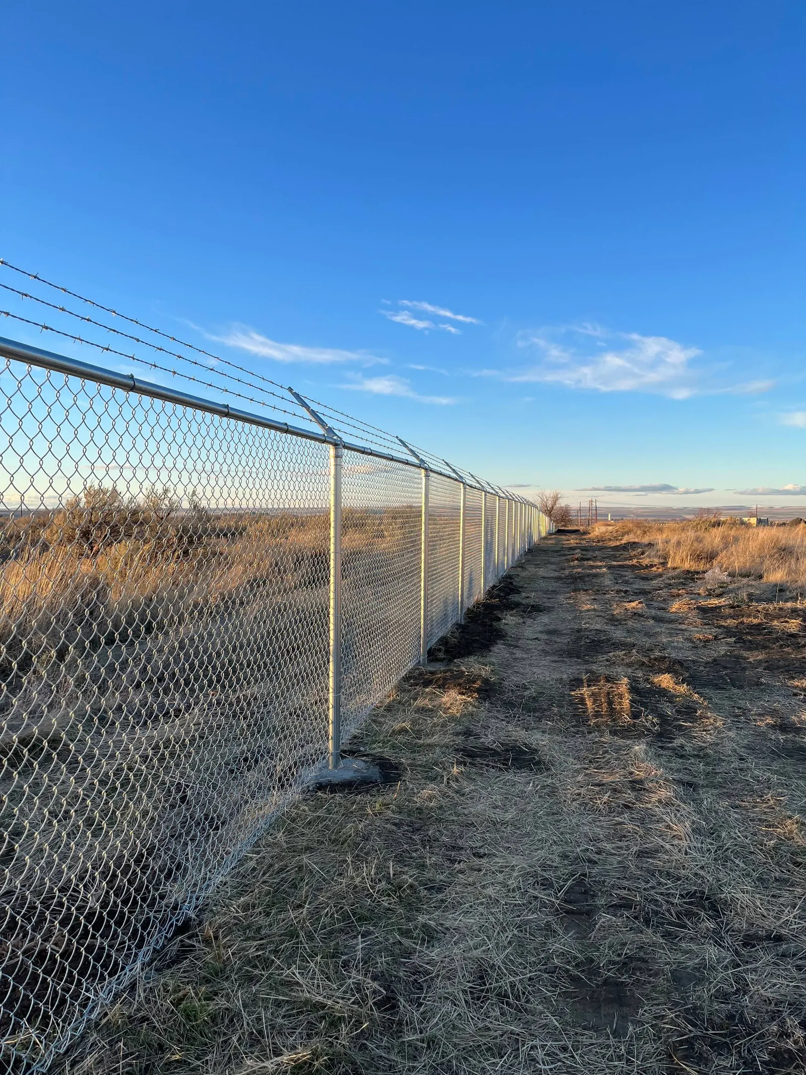 Galvanized chain-link fence around a residential yard