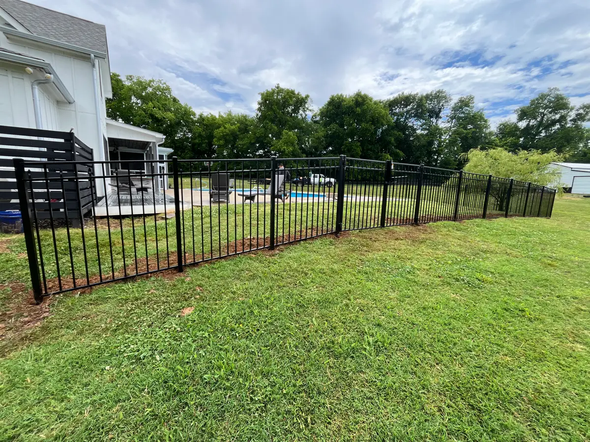 Black aluminum pool fence installation, installed by Duck Duck Fence