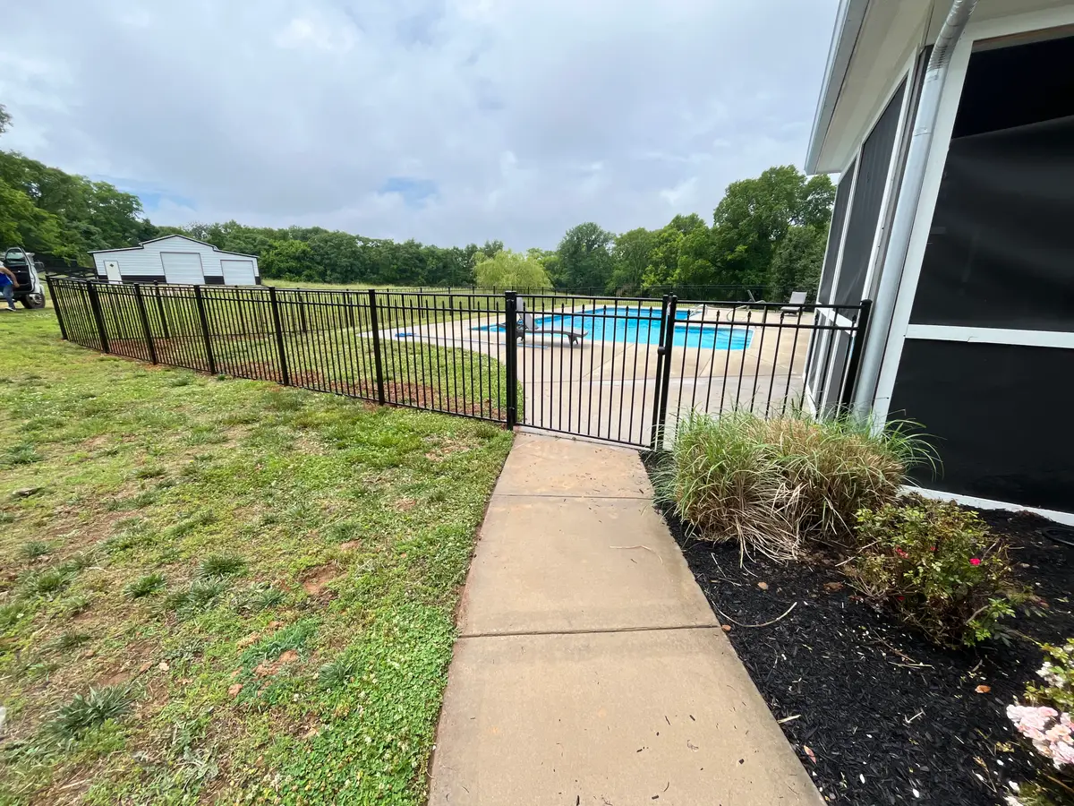 Pool fence cement walkway outdoor space, installed by Duck Duck Fence