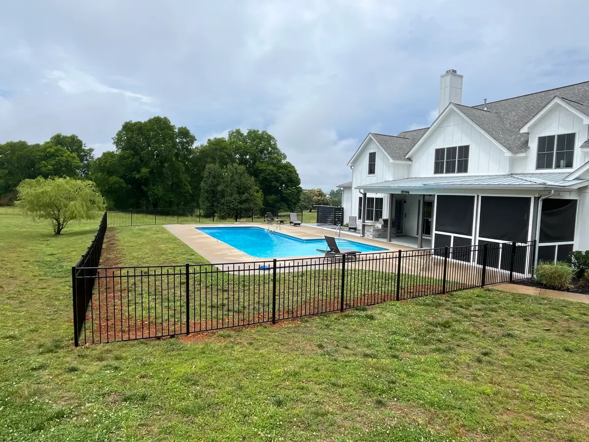 Pool fence with architectural house backdrop, installed by Duck Duck Fence