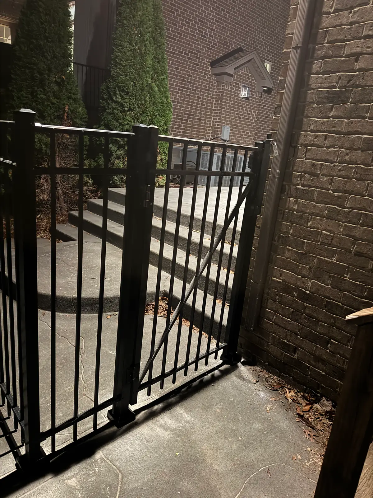 Black aluminum gate vertical pickets, installed by Duck Duck Fence