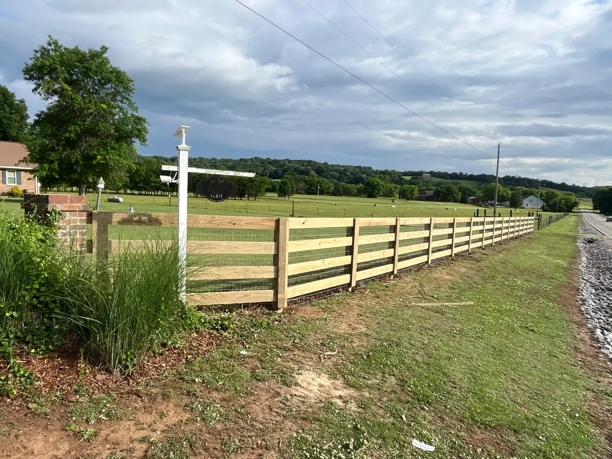 Long wood rail fence landscape, installed by Duck Duck Fence