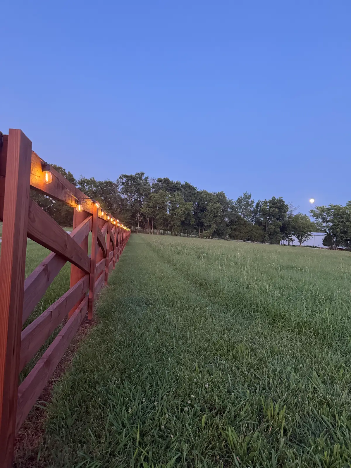 Burgundy ranch fence twilight landscape, installed by Duck Duck Fence