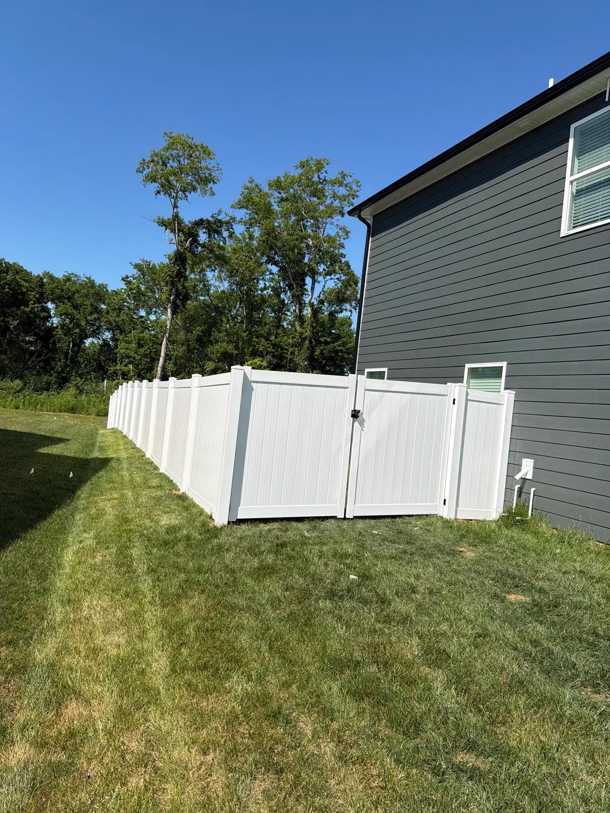 White vinyl privacy fence, installed by Duck Duck Fence