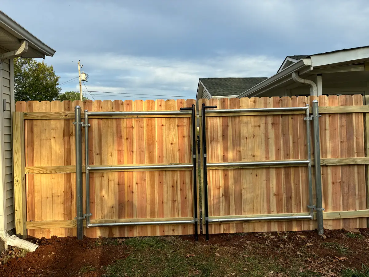Wood privacy fence with metal frame gates, installed by Duck Duck Fence