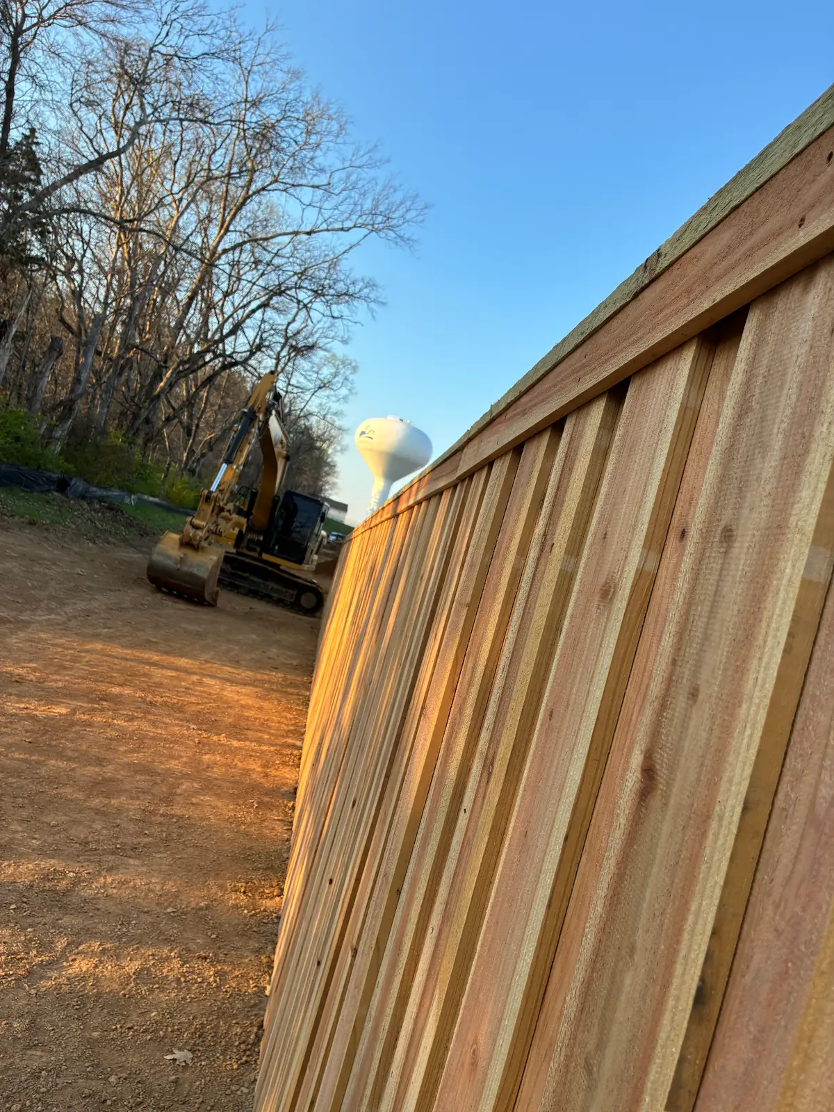 Wood fence alongside residential house, installed by Duck Duck Fence